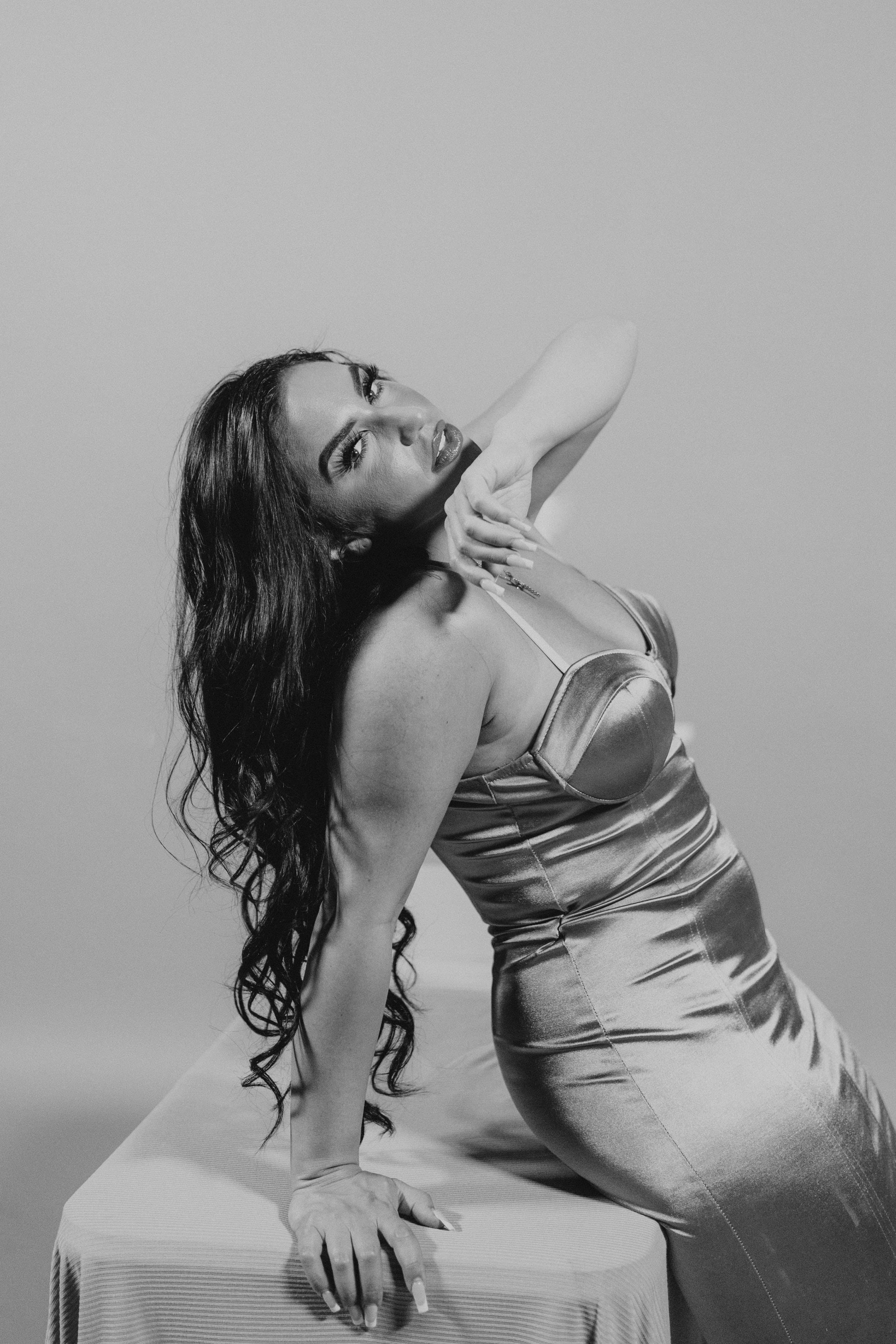 Black-and-white portrait of Bianca in a metallic dress.