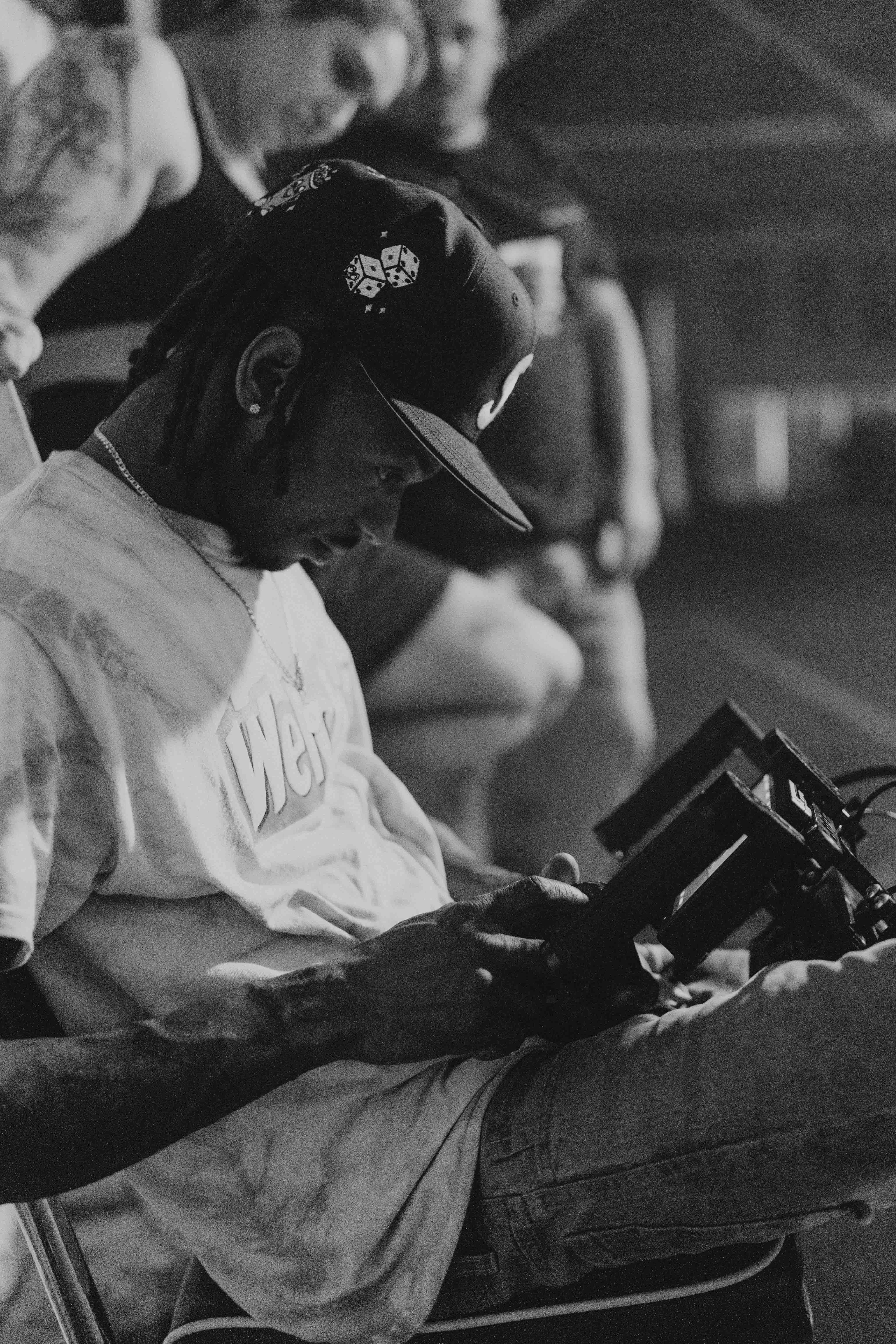 Black-and-white photograph of a crew member reviewing a production monitor.