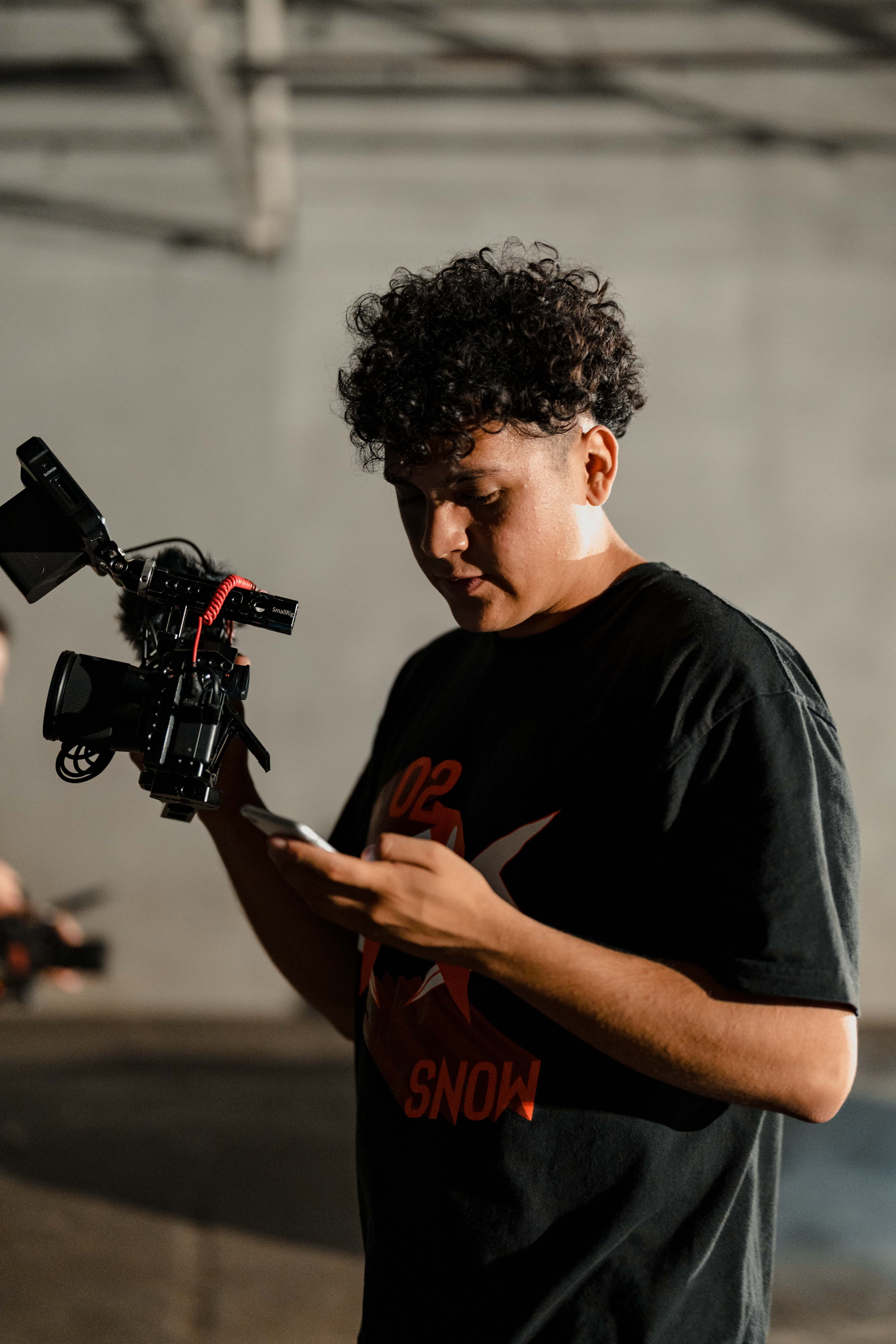 Camera operator checking a phone between takes.